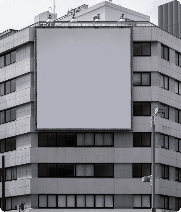 Large blank billboard mounted on a modern office building, ready for a brand's next launch